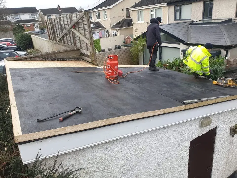 Flat garage roof mid-way through a torch-on felt installation
